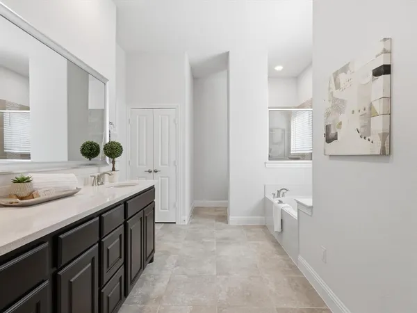 a bathroom with a double vanity sink and mirror