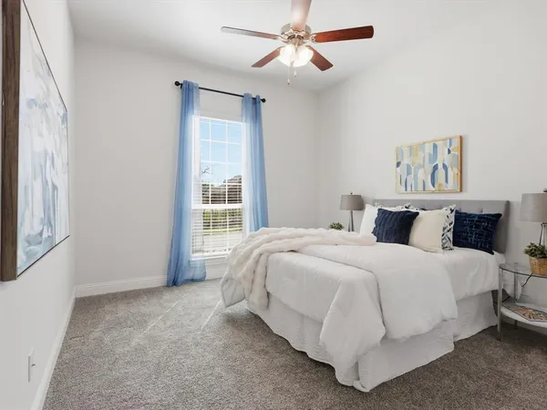 a spacious bedroom with a bed and a window