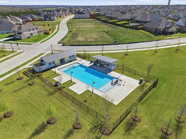 an aerial view of a swimming pool with a outdoor space