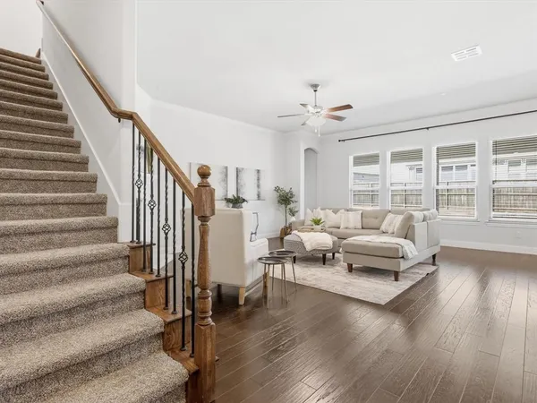 a living room with furniture and wooden floor