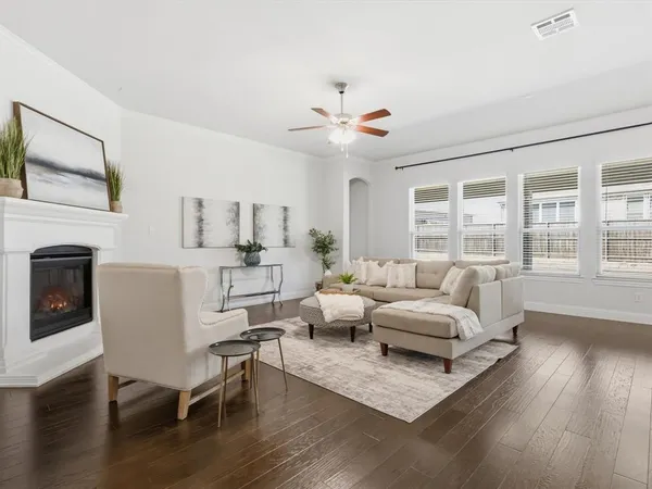 a living room with furniture fireplace and wooden floor