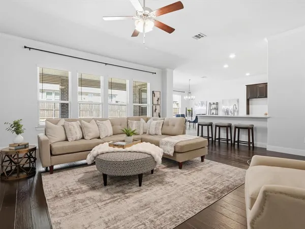 a living room with furniture a rug and a chandelier