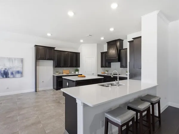 a kitchen with stainless steel appliances a sink stove and refrigerator