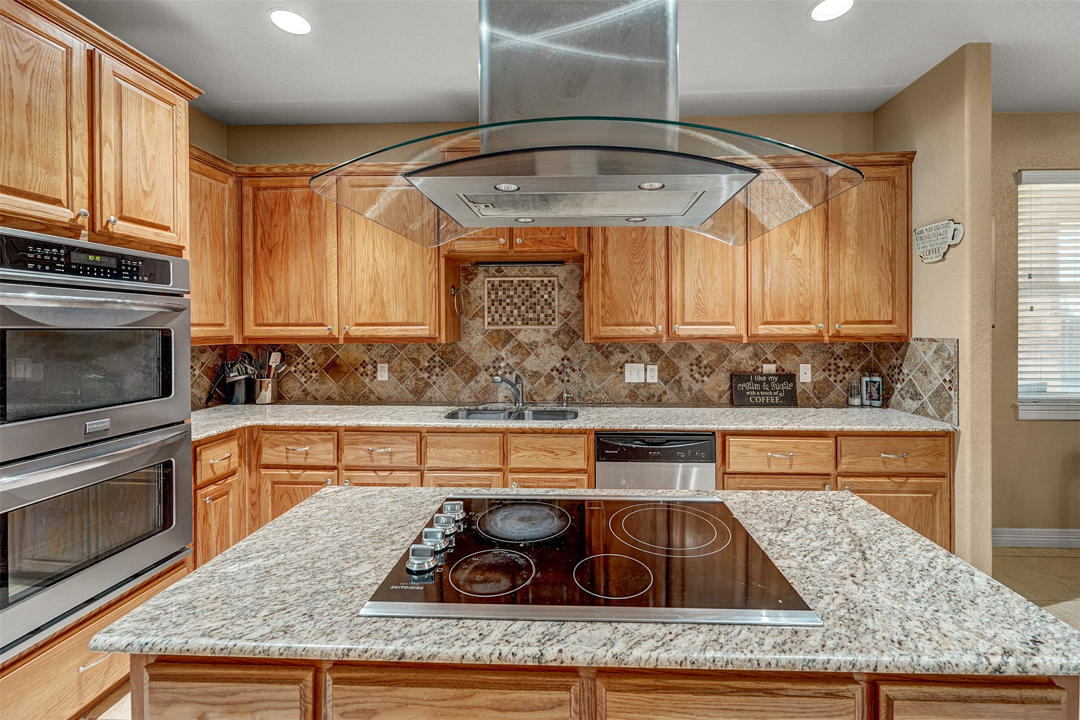 100 Magan Lane Jarrell, TX 76537 - Photo 11 of 32 a kitchen with a stove a sink and cabinets