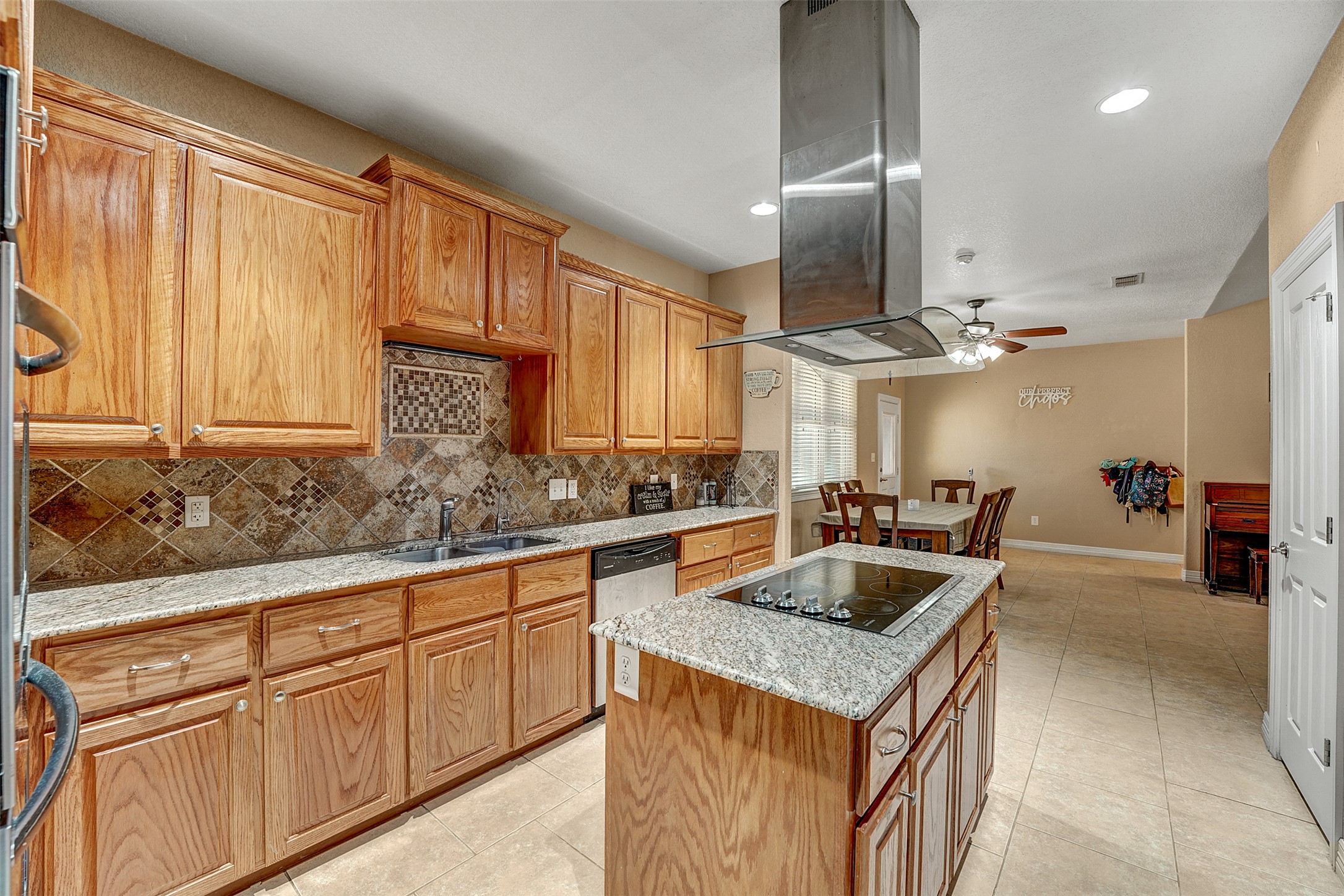 100 Magan Lane Jarrell, TX 76537 - Photo 12 of 32 a kitchen with stainless steel appliances granite countertop a sink dishwasher and cabinets with wooden floor