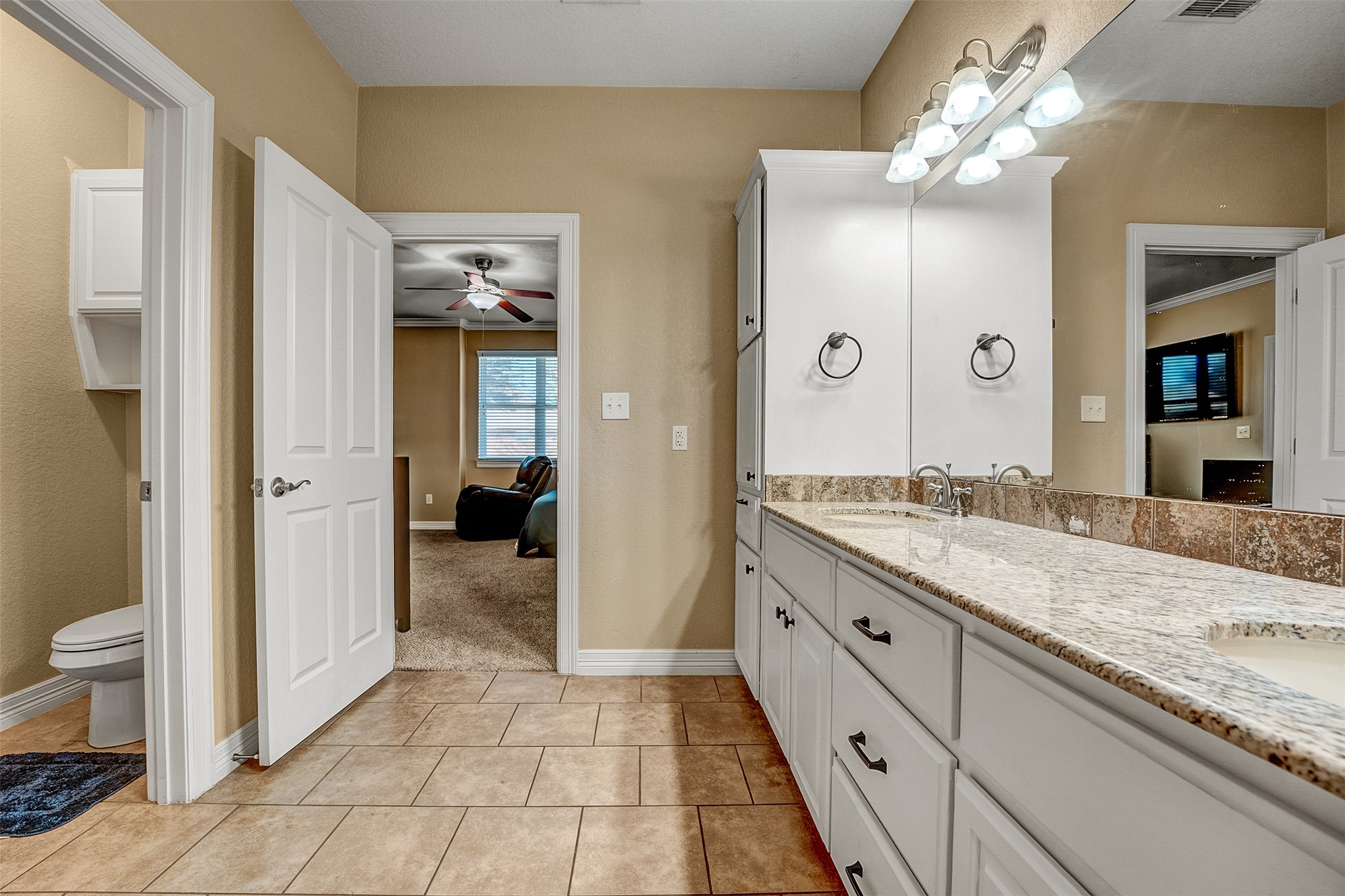 100 Magan Lane Jarrell, TX 76537 - Photo 20 of 32 a spacious bathroom with a granite countertop sink and a mirror