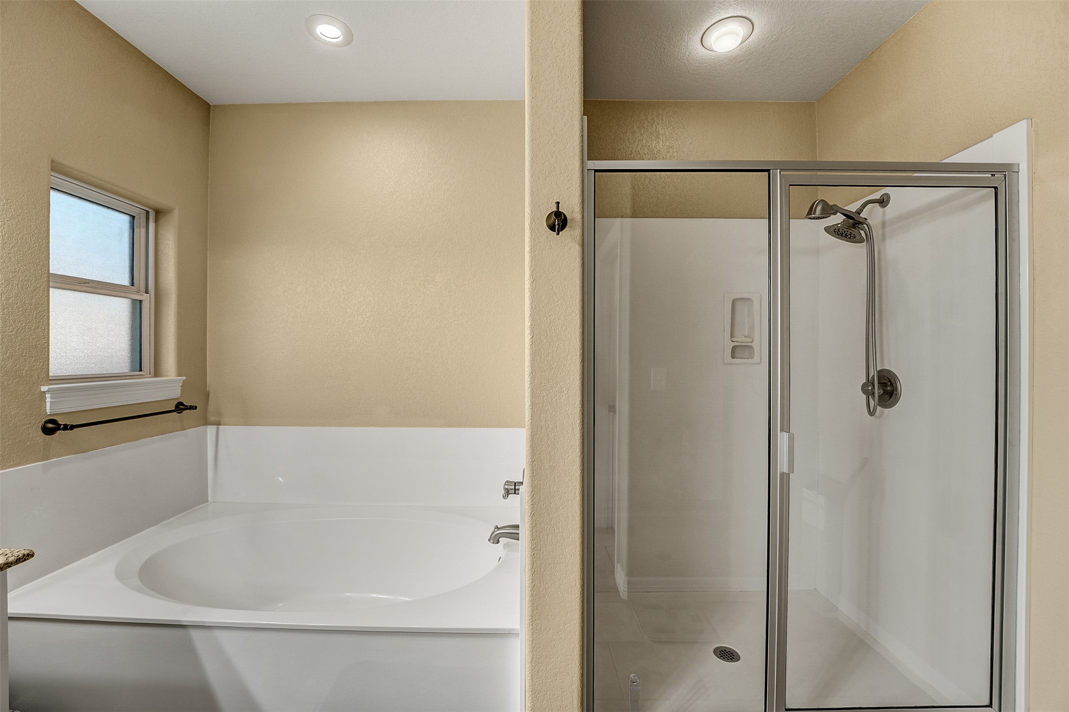 100 Magan Lane Jarrell, TX 76537 - Photo 21 of 32 a bathroom with a bathtub and a shower