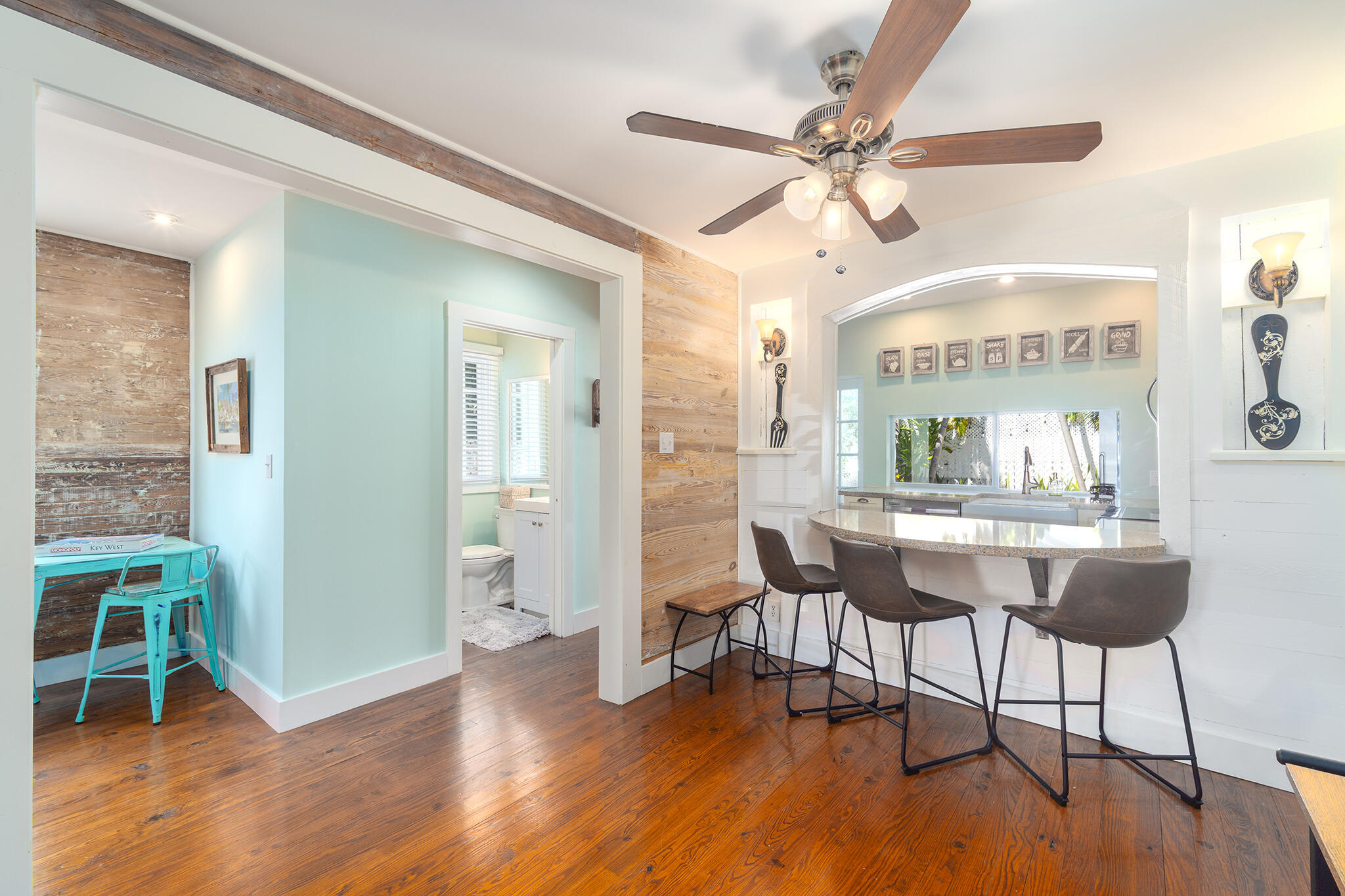 421 United Street Key West, FL 33040 - Photo 42 of 47 a dining room with wooden floor a glass table and chairs