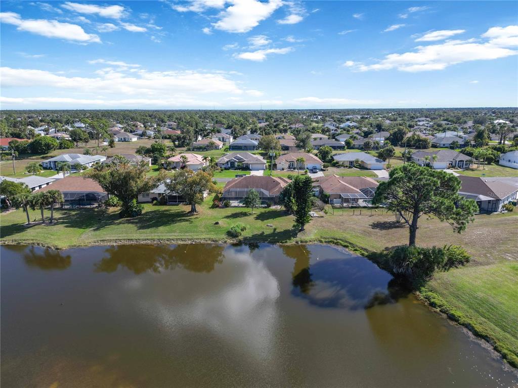 222 Sportsman Road Rotonda West, FL 33947 - Photo 12 of 54 a view of a lake with a city