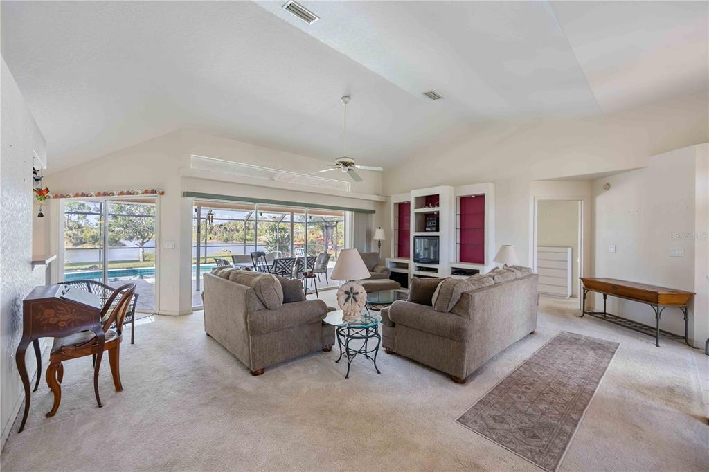 222 Sportsman Road Rotonda West, FL 33947 - Photo 13 of 54 a living room with furniture and a large window