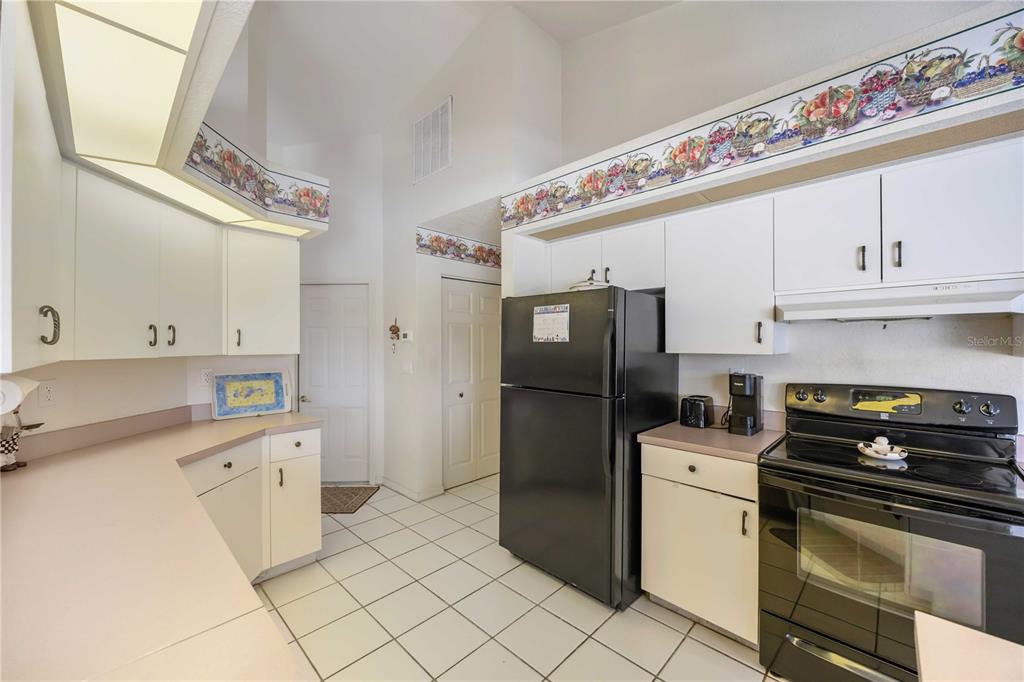 222 Sportsman Road Rotonda West, FL 33947 - Photo 17 of 54 a kitchen with stainless steel appliances a refrigerator sink and cabinets
