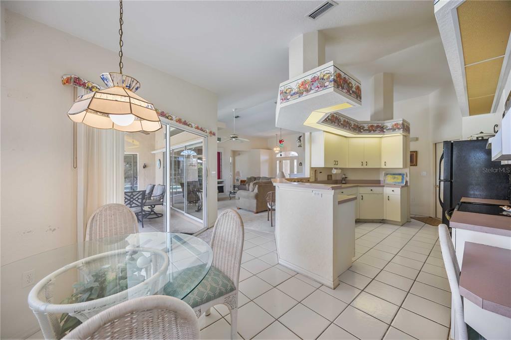 222 Sportsman Road Rotonda West, FL 33947 - Photo 19 of 54 a kitchen with cabinets and chairs