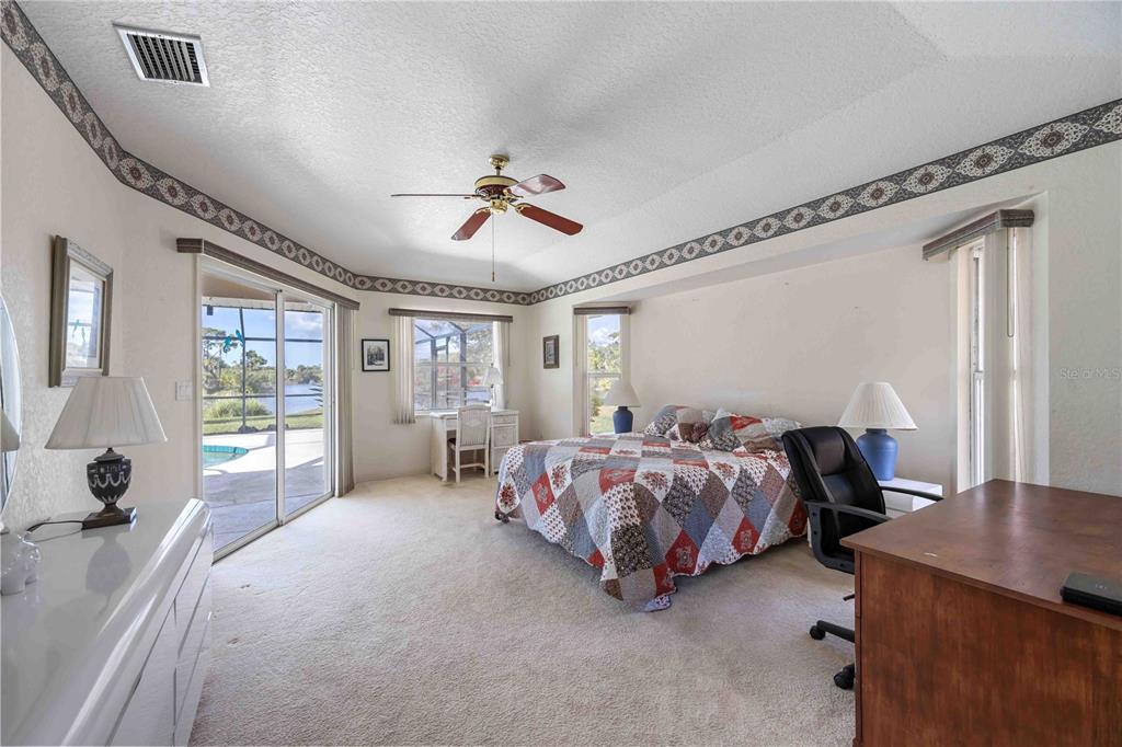 222 Sportsman Road Rotonda West, FL 33947 - Photo 22 of 54 a spacious bedroom with a bed and a table chair
