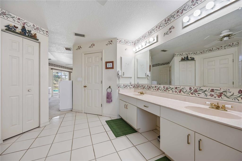 222 Sportsman Road Rotonda West, FL 33947 - Photo 26 of 54 a spacious bathroom with a double vanity sink mirror and shower