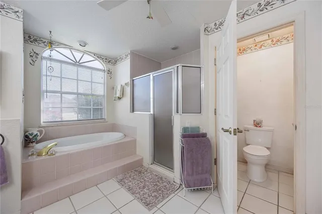 a living room with furniture a large window and a flat screen tv