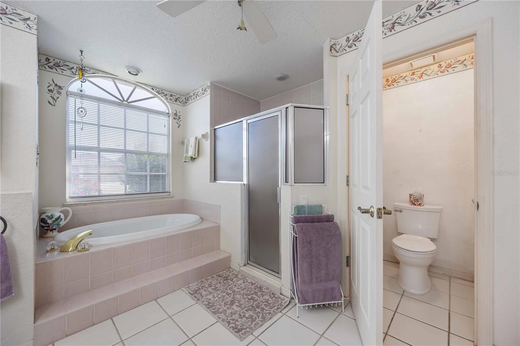 222 Sportsman Road Rotonda West, FL 33947 - Photo 27 of 54 a bathroom with a granite countertop bathtub shower and toilet