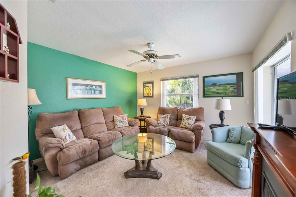 222 Sportsman Road Rotonda West, FL 33947 - Photo 29 of 54 a living room with furniture a large window and a flat screen tv