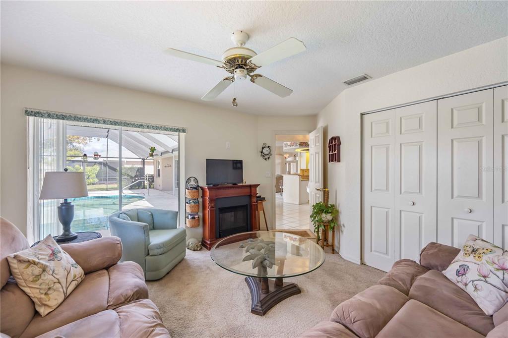 222 Sportsman Road Rotonda West, FL 33947 - Photo 30 of 54 a living room with furniture a ceiling fan and a window