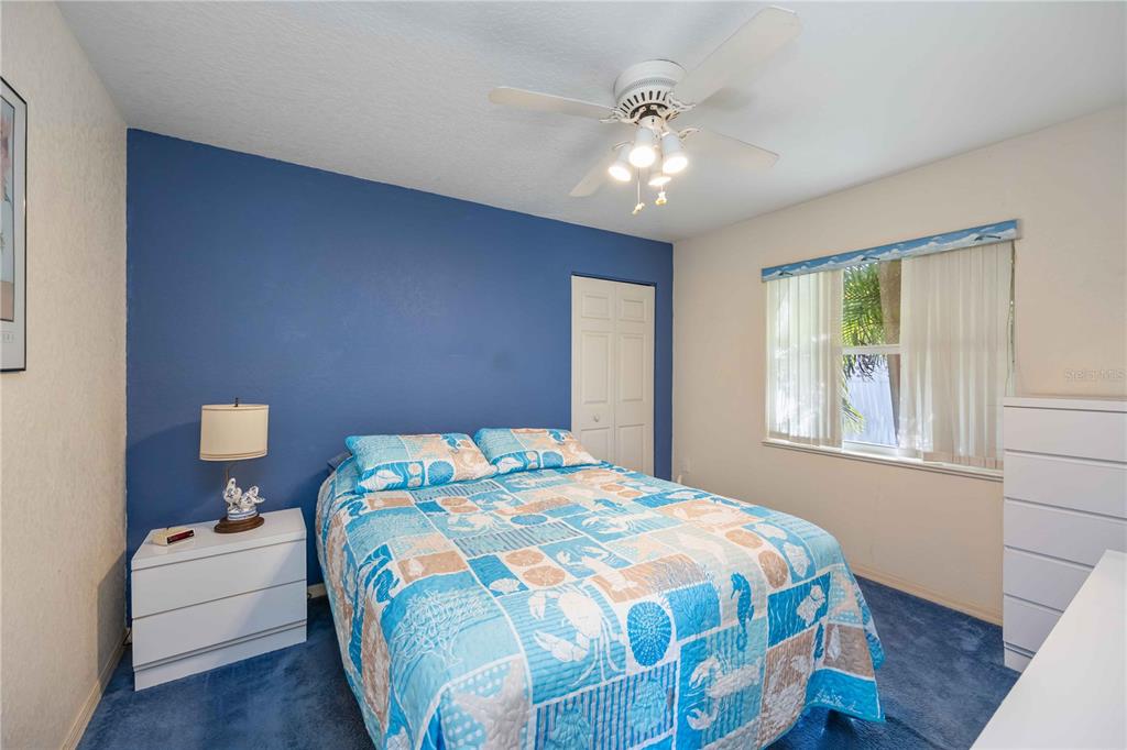222 Sportsman Road Rotonda West, FL 33947 - Photo 31 of 54 a bedroom with a bed and a chandelier