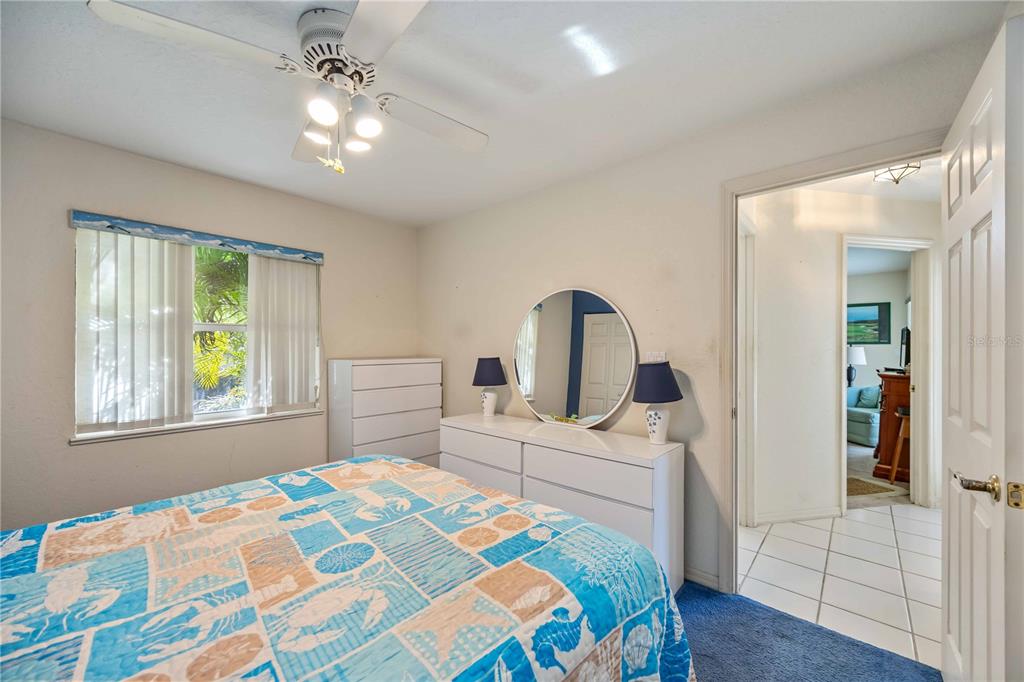 222 Sportsman Road Rotonda West, FL 33947 - Photo 32 of 54 a bedroom with a bed and a chandelier