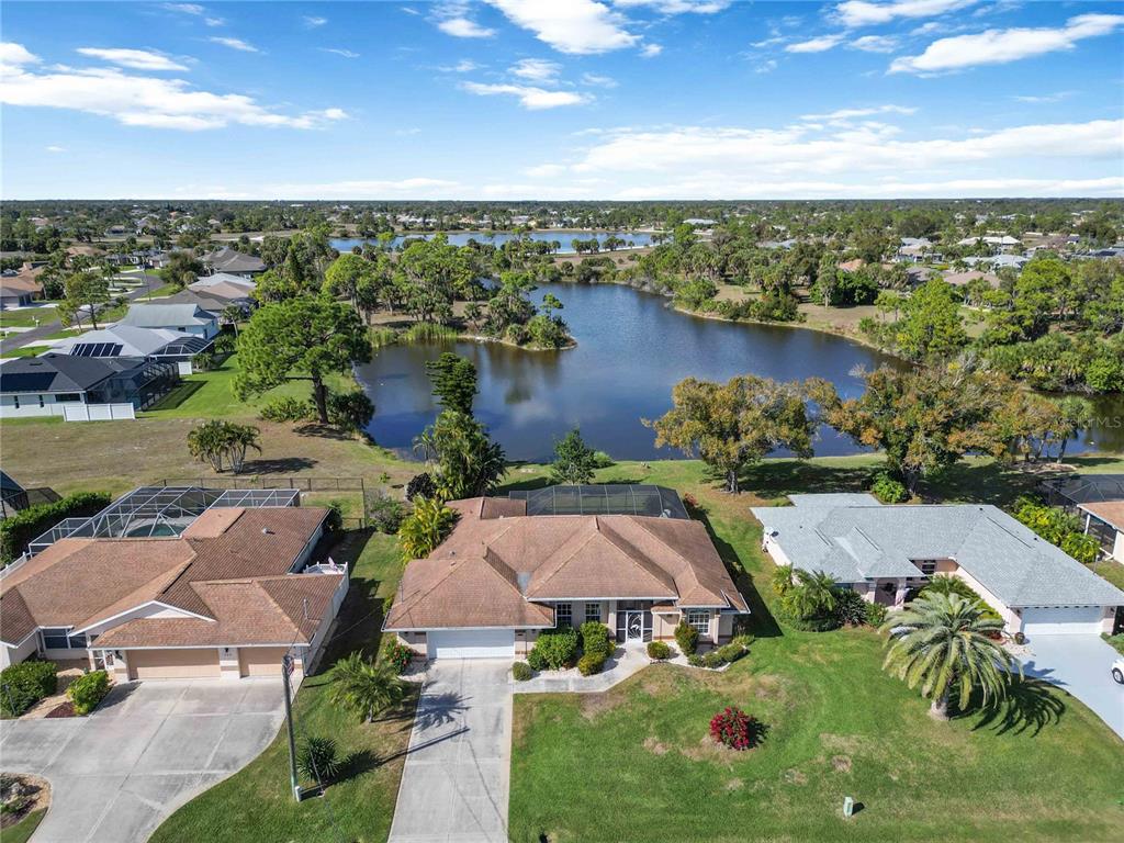 222 Sportsman Road Rotonda West, FL 33947 - Photo 47 of 54 a view of a lake with a yard