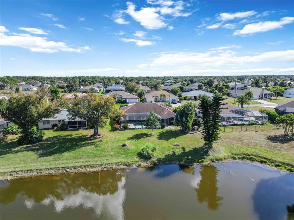 222 Sportsman Road Rotonda West, FL 33947 - Photo 49 of 54 a view of a lake with a city