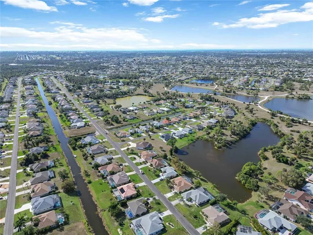 a aerial view of a house with pool and a garden