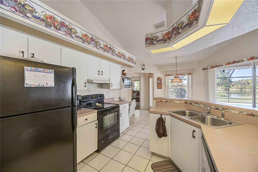 222 Sportsman Road Rotonda West, FL 33947 - Photo 8 of 54 a kitchen with stainless steel appliances granite countertop a sink stove and refrigerator