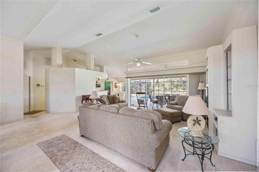 222 Sportsman Road Rotonda West, FL 33947 - Photo 9 of 54 a living room with furniture and a large window