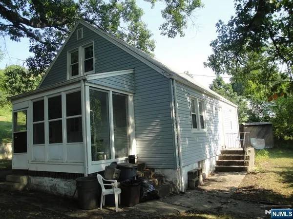 a front view of a house with sitting area