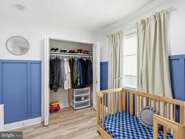 a view of a hallway with wooden floor and windows