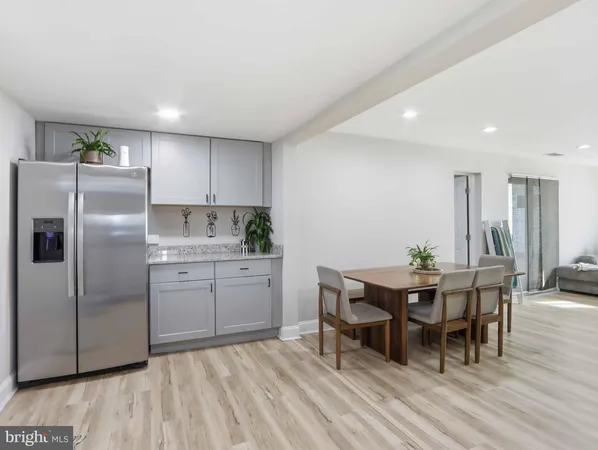a kitchen with granite countertop cabinets stainless steel appliances and dining table
