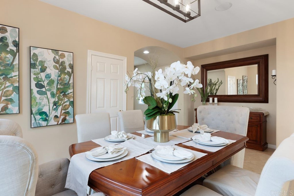 979 Canyon Heights San Marcos, CA 92078 - Photo 15 of 58 a view of a dining room with furniture a potted plant and wooden floor