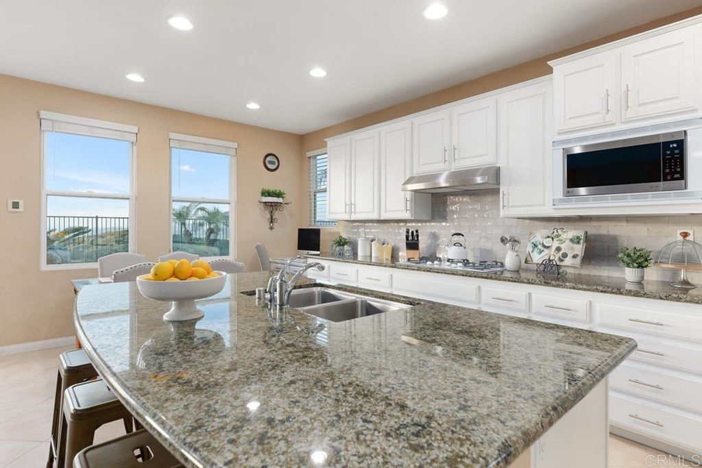 979 Canyon Heights San Marcos, CA 92078 - Photo 18 of 58 a kitchen with stainless steel appliances granite countertop a sink stove and cabinets