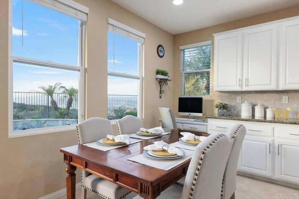 979 Canyon Heights San Marcos, CA 92078 - Photo 21 of 58 a kitchen with a table chairs and a stove