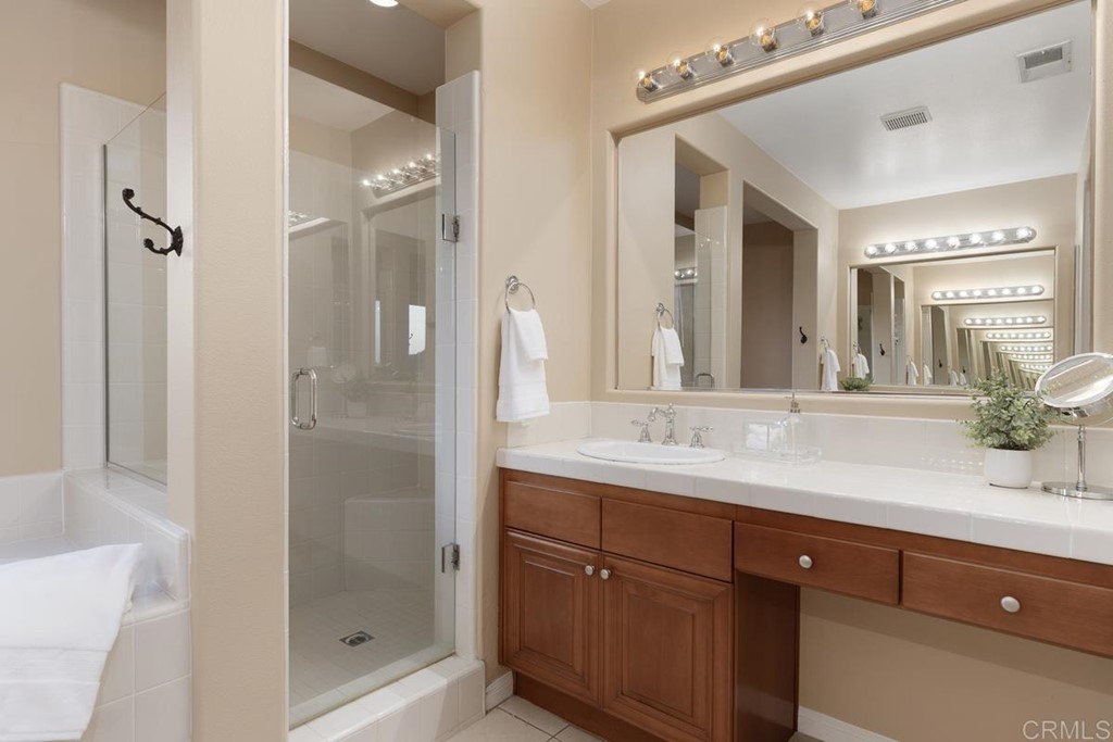 979 Canyon Heights San Marcos, CA 92078 - Photo 33 of 58 a bathroom with a granite countertop sink mirror and shower