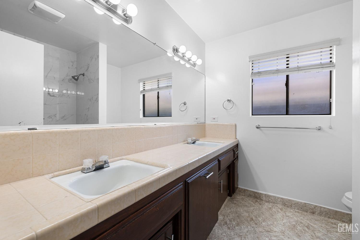 Undisclosed Address Bakersfield, CA 93309 - Photo 42 of 59 a bathroom with a sink and a mirror