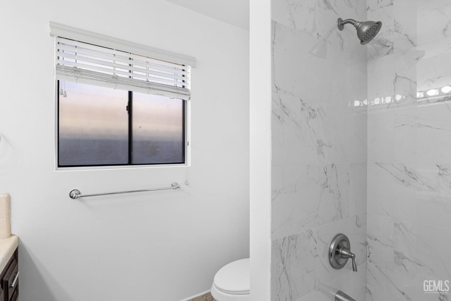 Undisclosed Address Bakersfield, CA 93309 - Photo 43 of 59 a bathroom with a shower and toilet