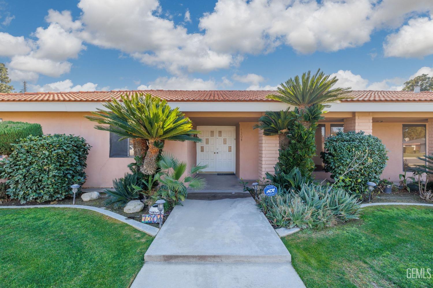 Undisclosed Address Bakersfield, CA 93309 - Photo 6 of 59 a front view of a house with garden