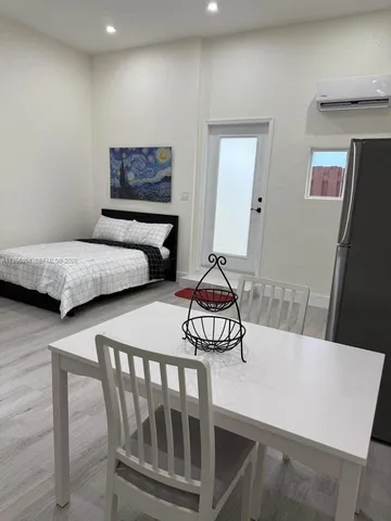 a bedroom with two beds and a dresser