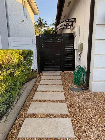 a view of a pathway along the house