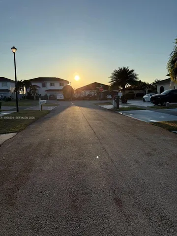 a view of street with parked cars
