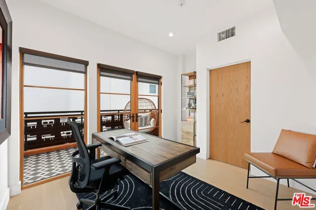 a reading room with furniture book shelf and a floor to ceiling window