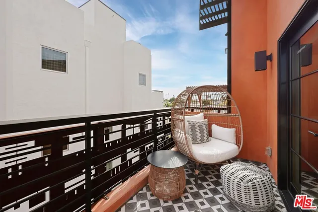 a bedroom with a bed couch and a large window