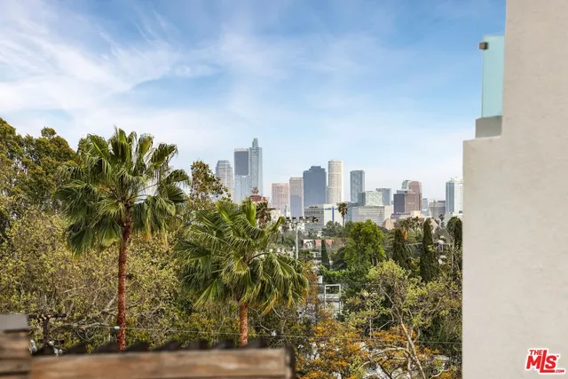 a view of patio with couches and city view