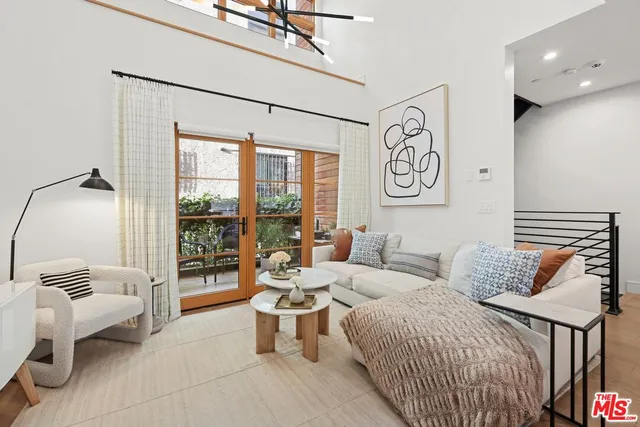 a living room with furniture kitchen view and a table