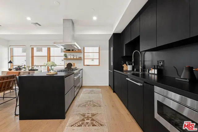 a kitchen with stainless steel appliances granite countertop a sink and a cabinets