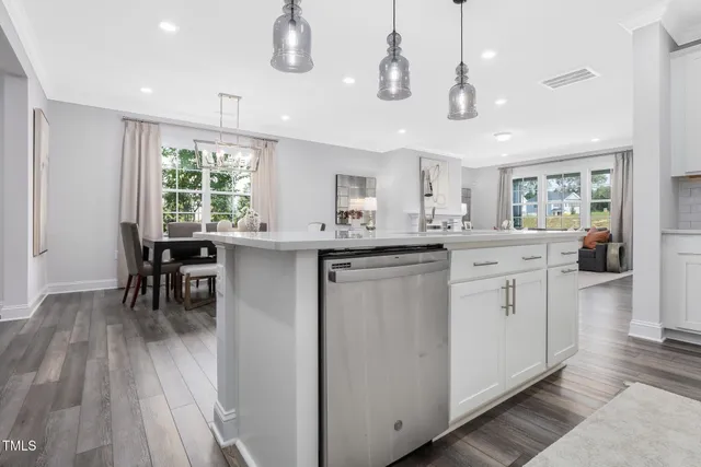 a kitchen with a sink window and cabinets