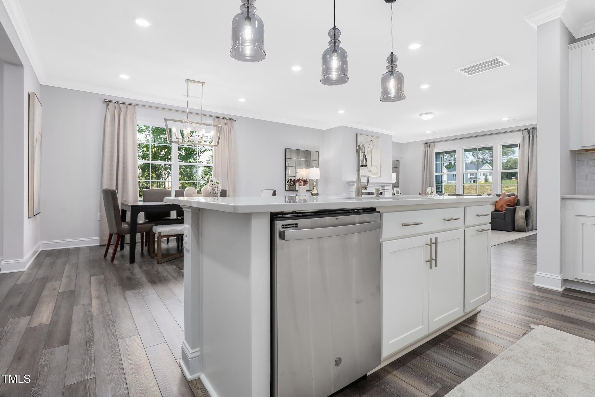 329 Calvander Lane Apex, NC 27539 - Photo 12 of 47 a kitchen with a sink window and cabinets