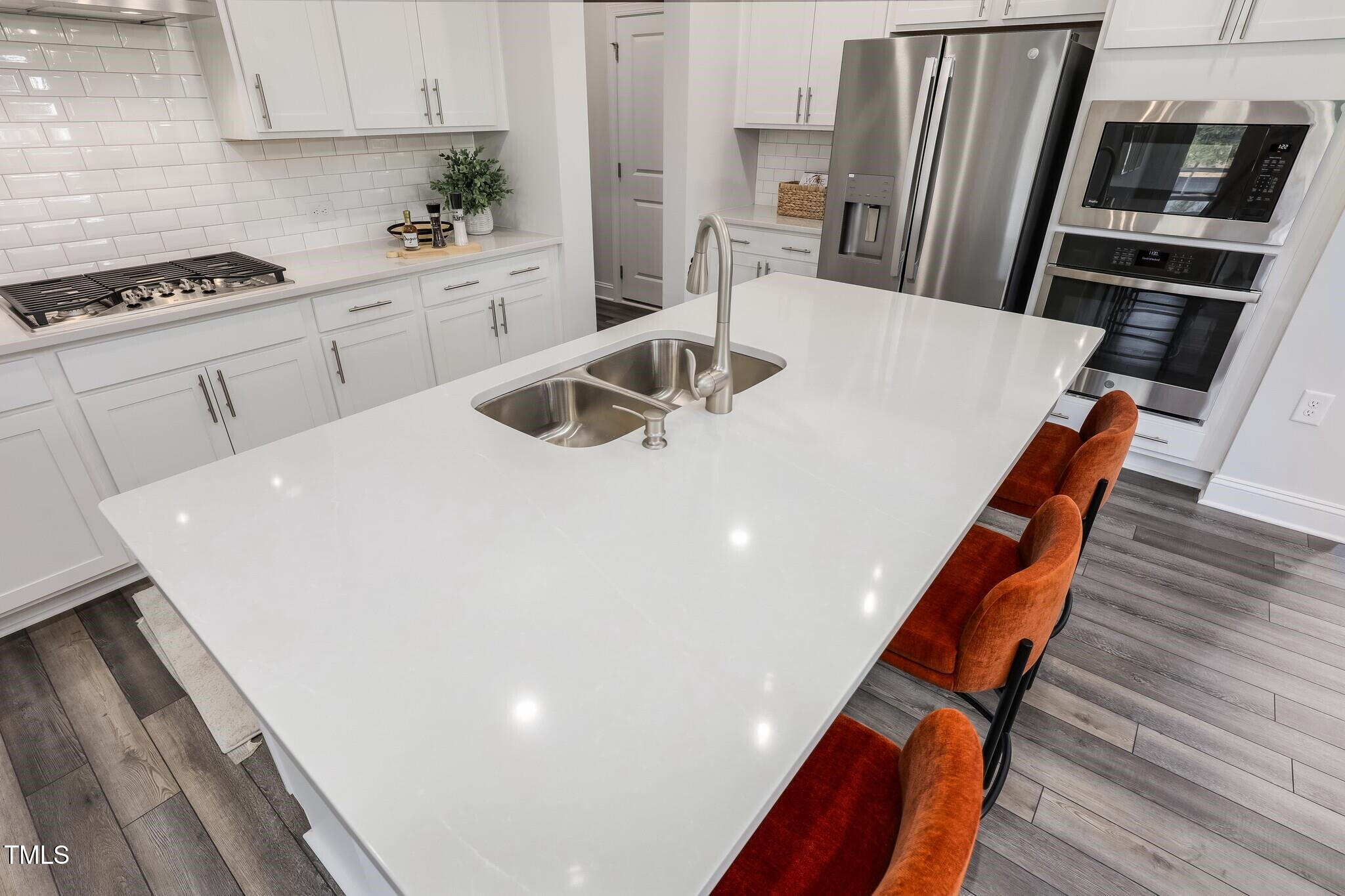 329 Calvander Lane Apex, NC 27539 - Photo 13 of 47 a kitchen with stainless steel appliances a stove a sink a microwave and a refrigerator